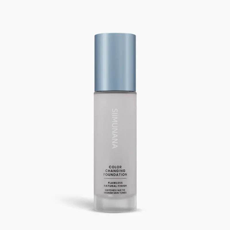Foundation bottle with blue cap on a white background