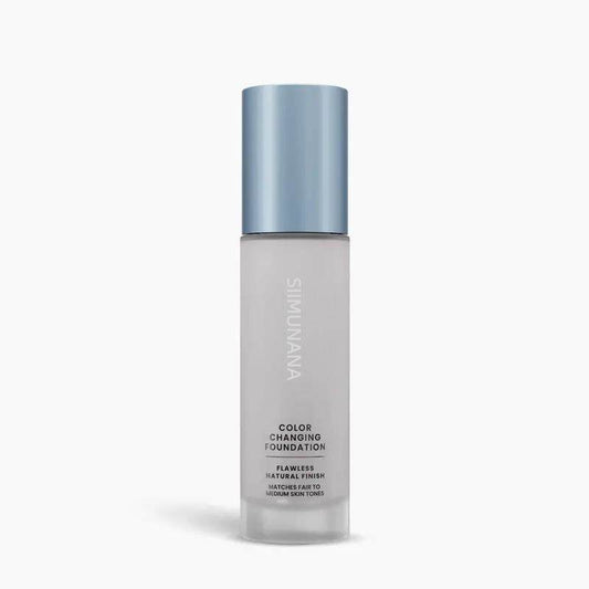 Foundation bottle with blue cap on a white background